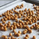 a picture of chickpeas cooked on a baking sheet
