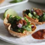 a close up of mini taco cups on a plate