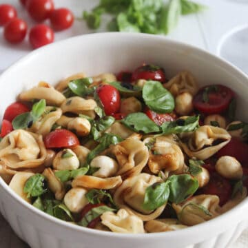 a close up of tortellini salad in a bowl