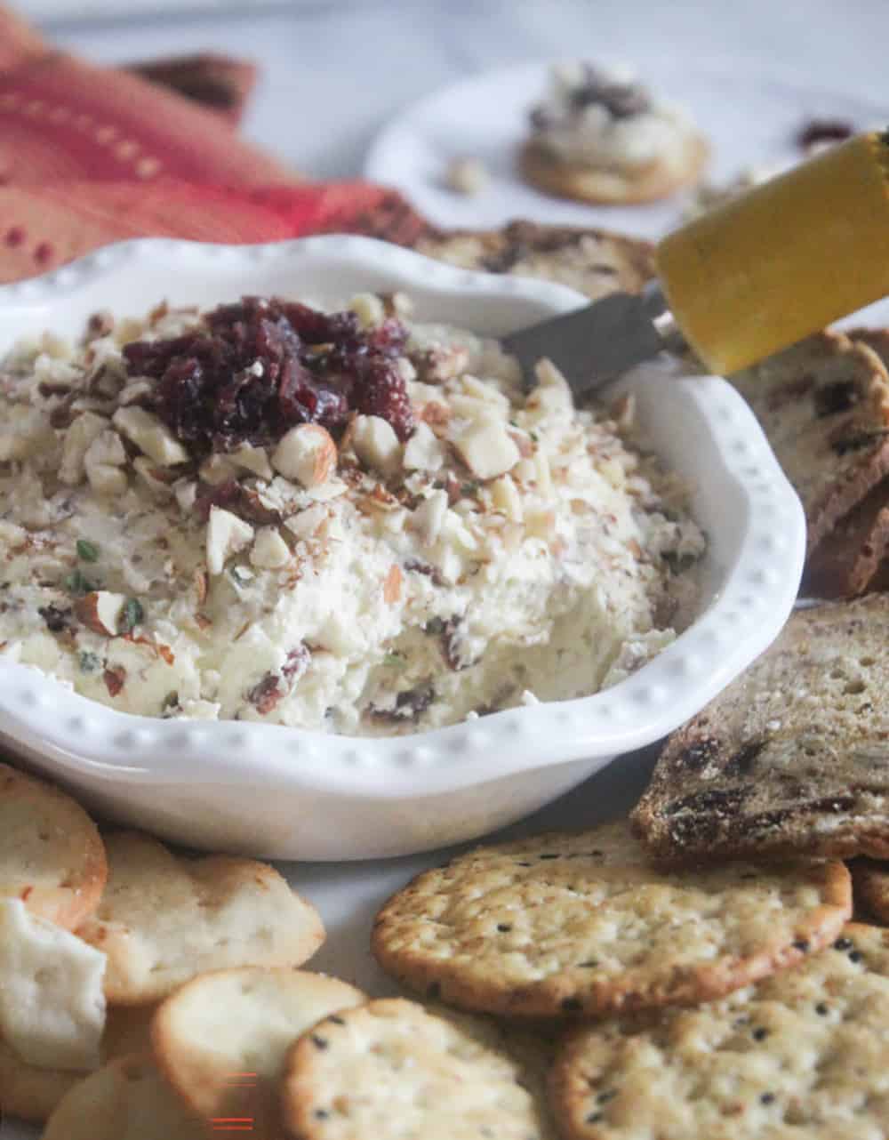 Cranberry dip in a white bowl with a knife in it
