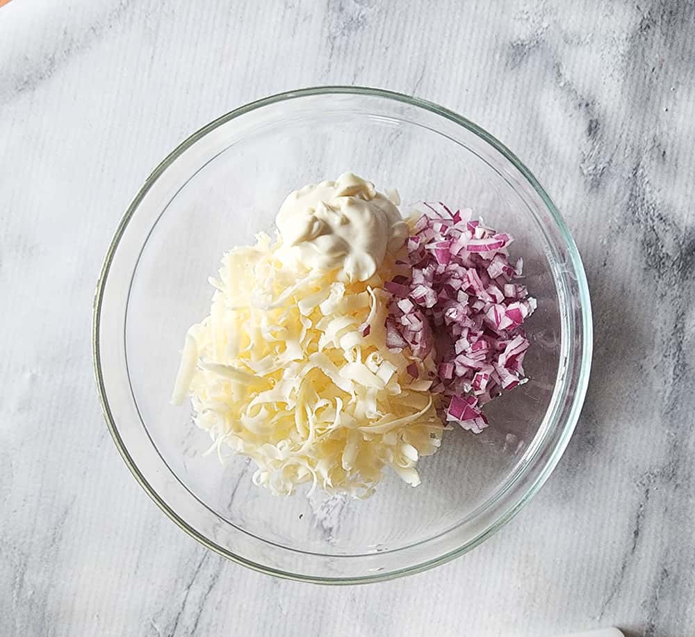 cheese mayonnaise and onions in a bowl