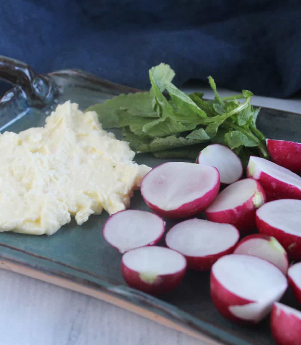 A close up picture of butter and radishes