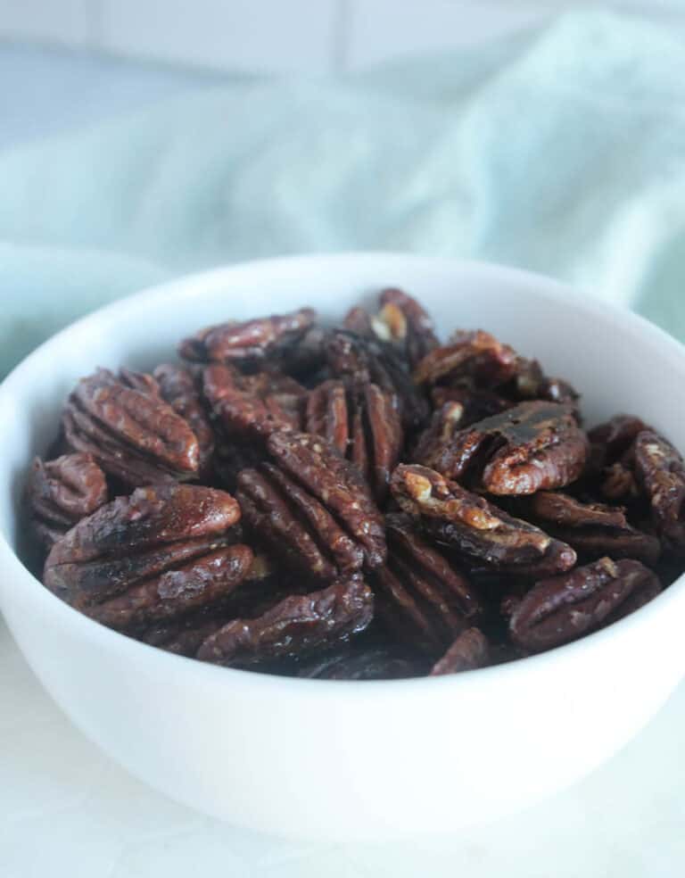 A picture of candied pecans in a white bowl