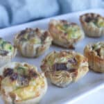 a picture of several mini quiche on a white platter