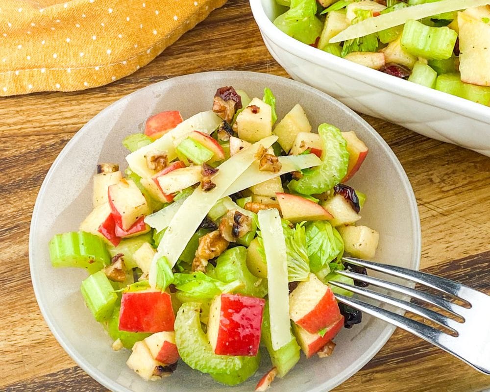 overhead view of celery apple salad in a bowl with a fork